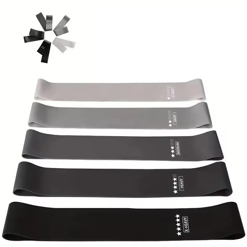 Set of resistance bands in black, gray, and white on a white background