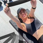 Woman exercising with Fitvect  resistance bands on a tiled floor